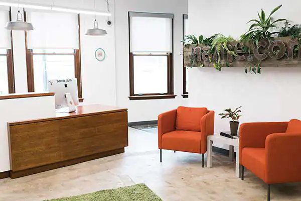 The Name.com office reception desk and two red chairs