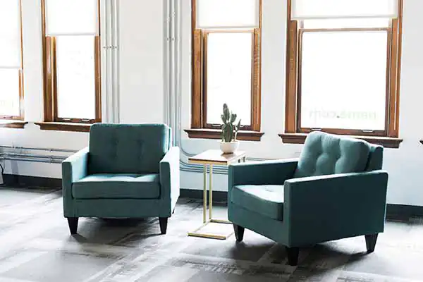 Two blue chairs in front of a window in the Name.com office