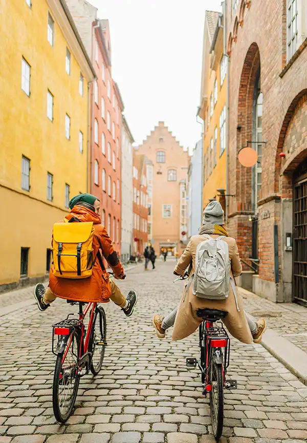 A male and female having fun while riding their bikes through Europe