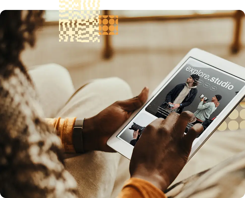 Looking over the shoulder of a person holding an iPad with a website on it